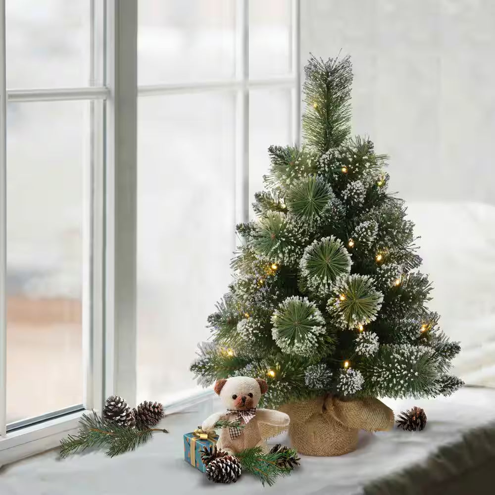 2 Ft. Green Prelit Flocked Table Top Artificial Christmas Tree with 35 Lights in Tan Sac